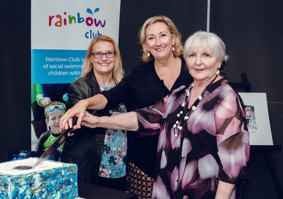 Cutting the cake celebrating 50 years of Rainbow Club